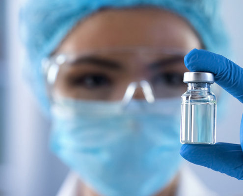 Scientist looking at ampoule in the bio tech industry