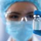 Scientist looking at ampoule in the bio tech industry