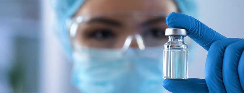Scientist looking at ampoule in the bio tech industry